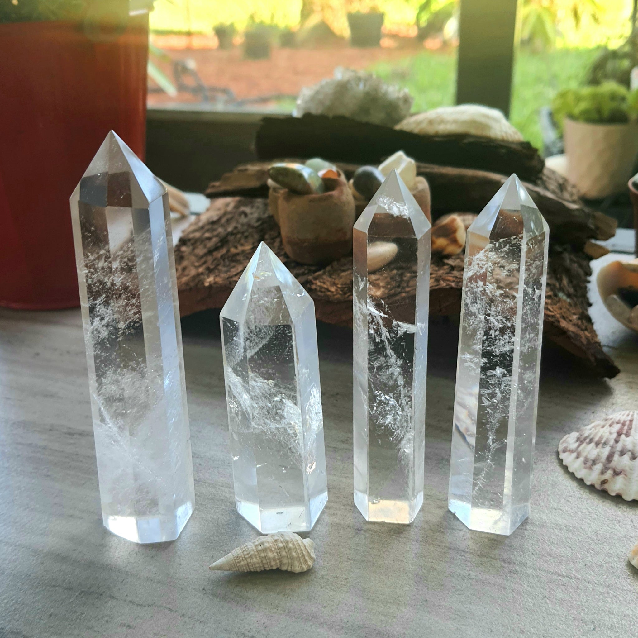 Four clear quartz points of different heights from Roxxy Crystals